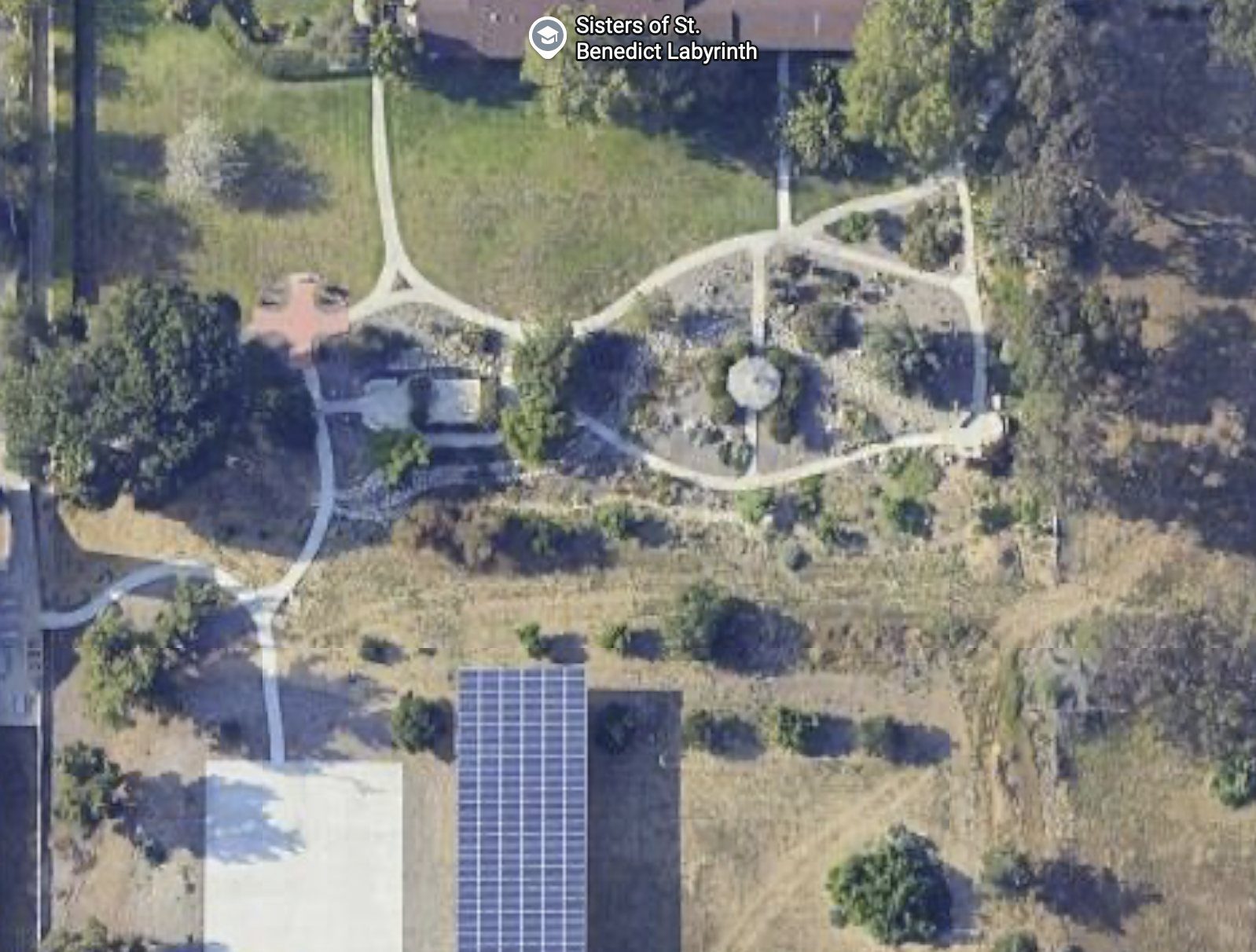 Satellite view of the Serra House prayer garden and labyrinth, with the white-roof pavilion and solar panels to the south