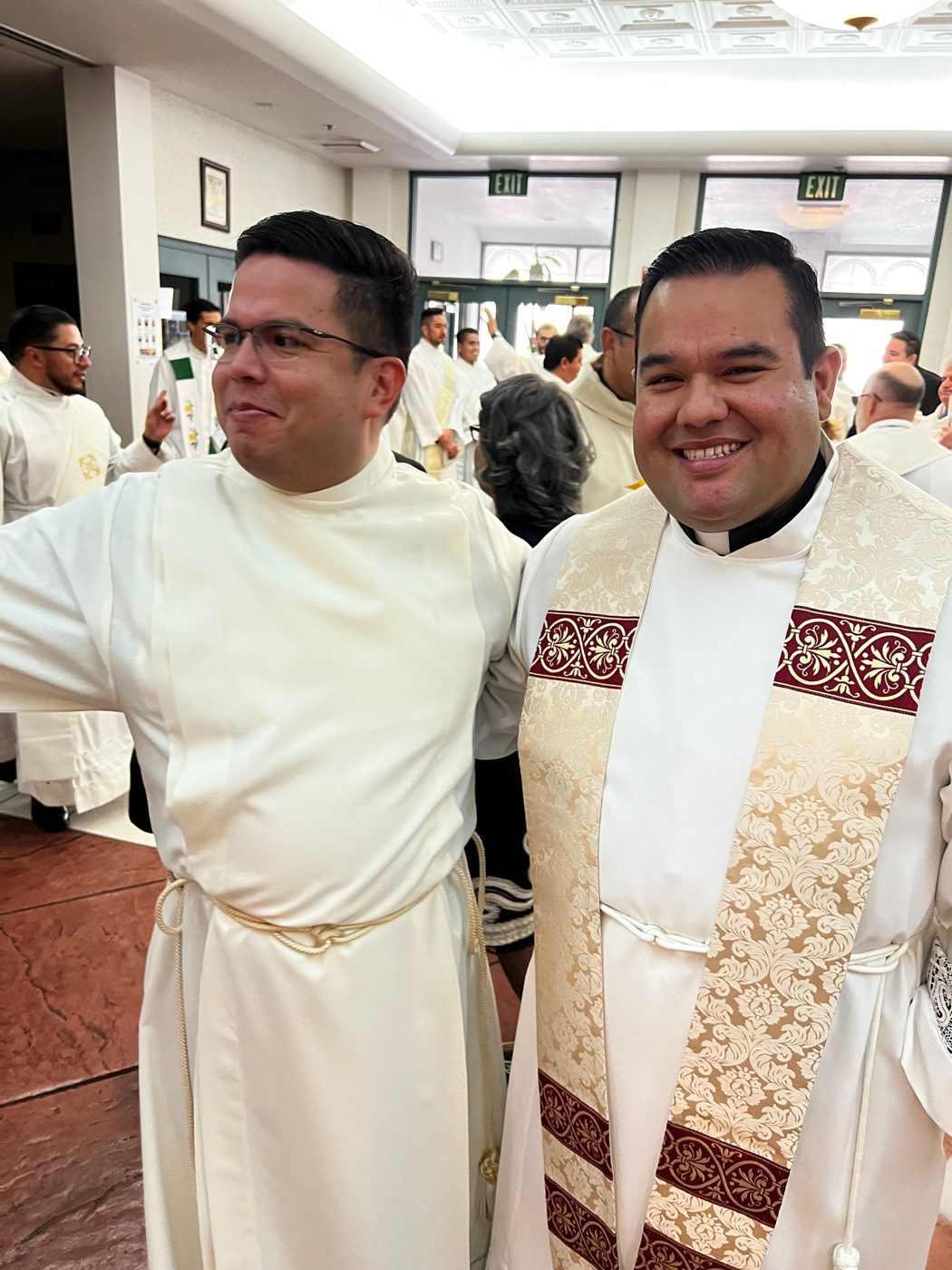Two priests of the Diocese of San Bernardino smiling after Mass