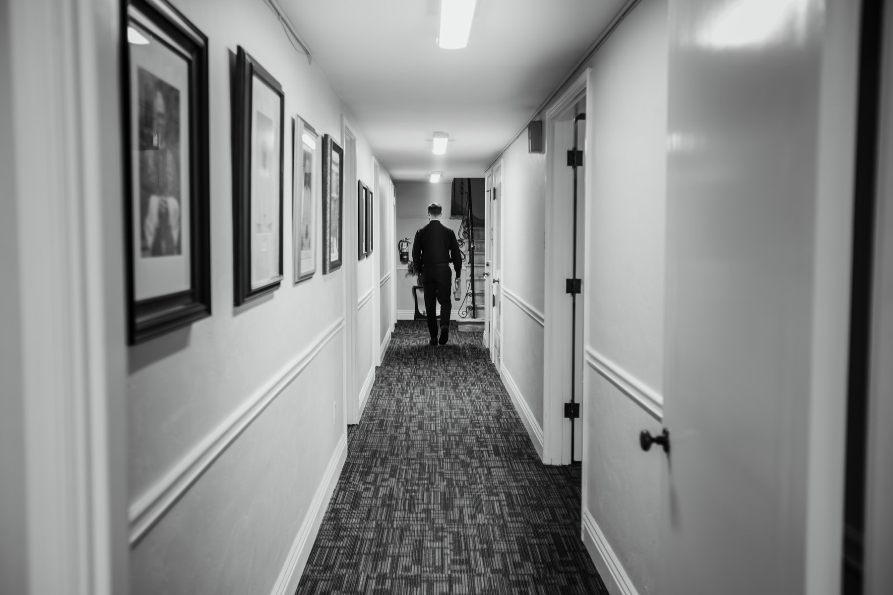 Father Larry walks away down the hallway