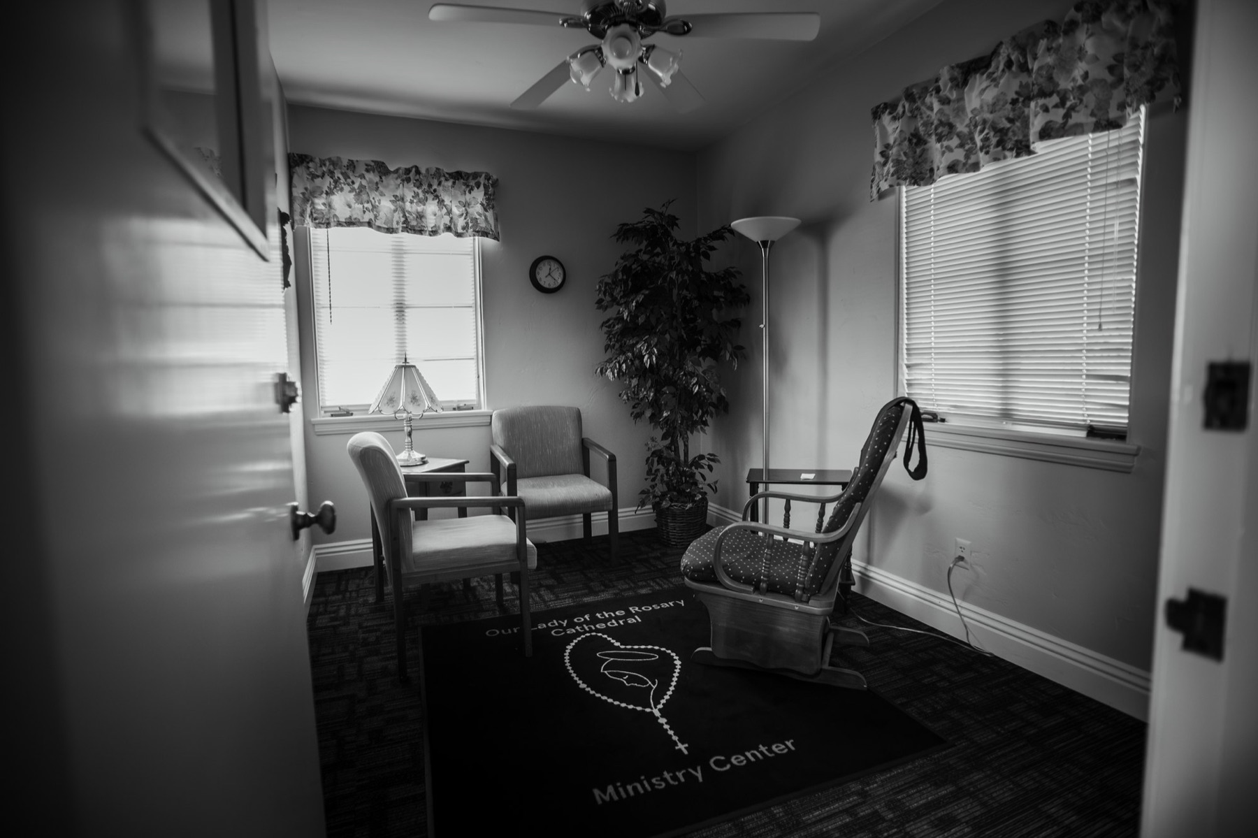 A quiet ministry room with chairs and a kneeler