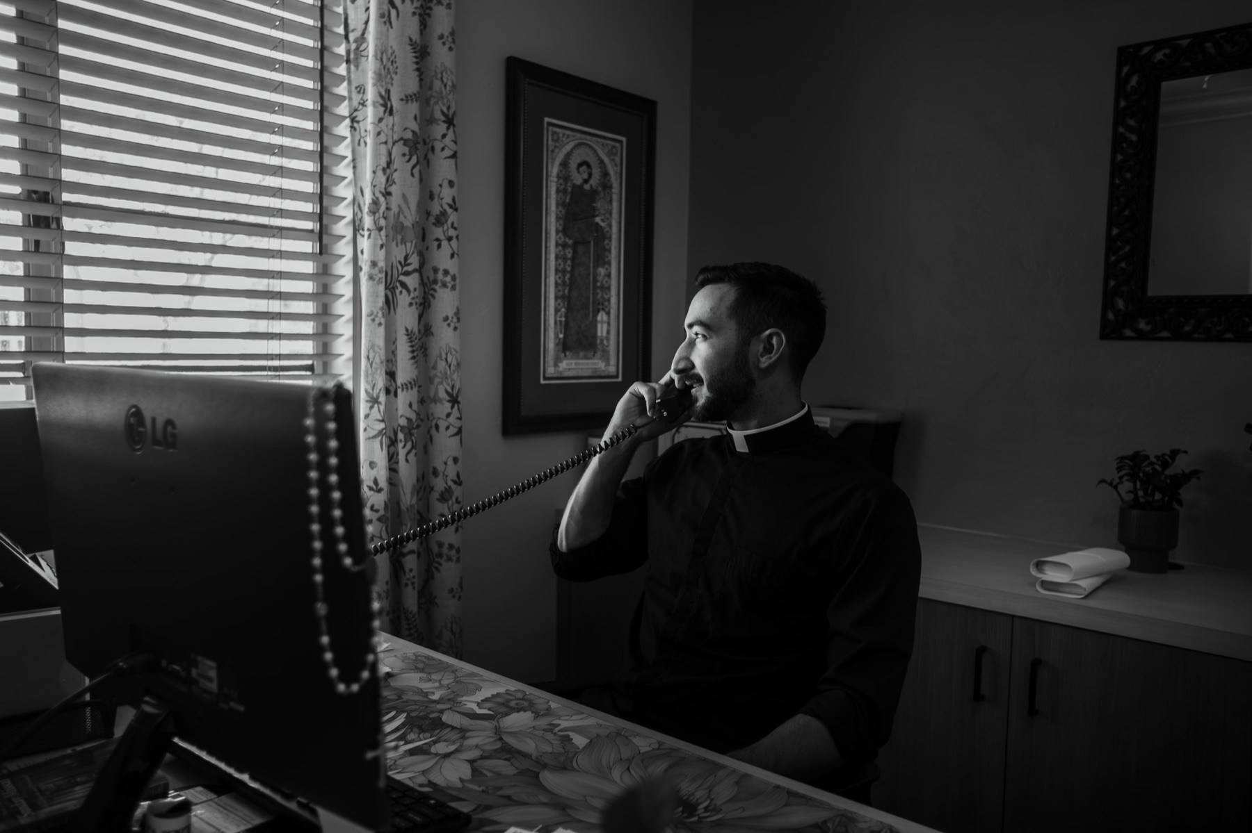 Father Larry answers the parish phone