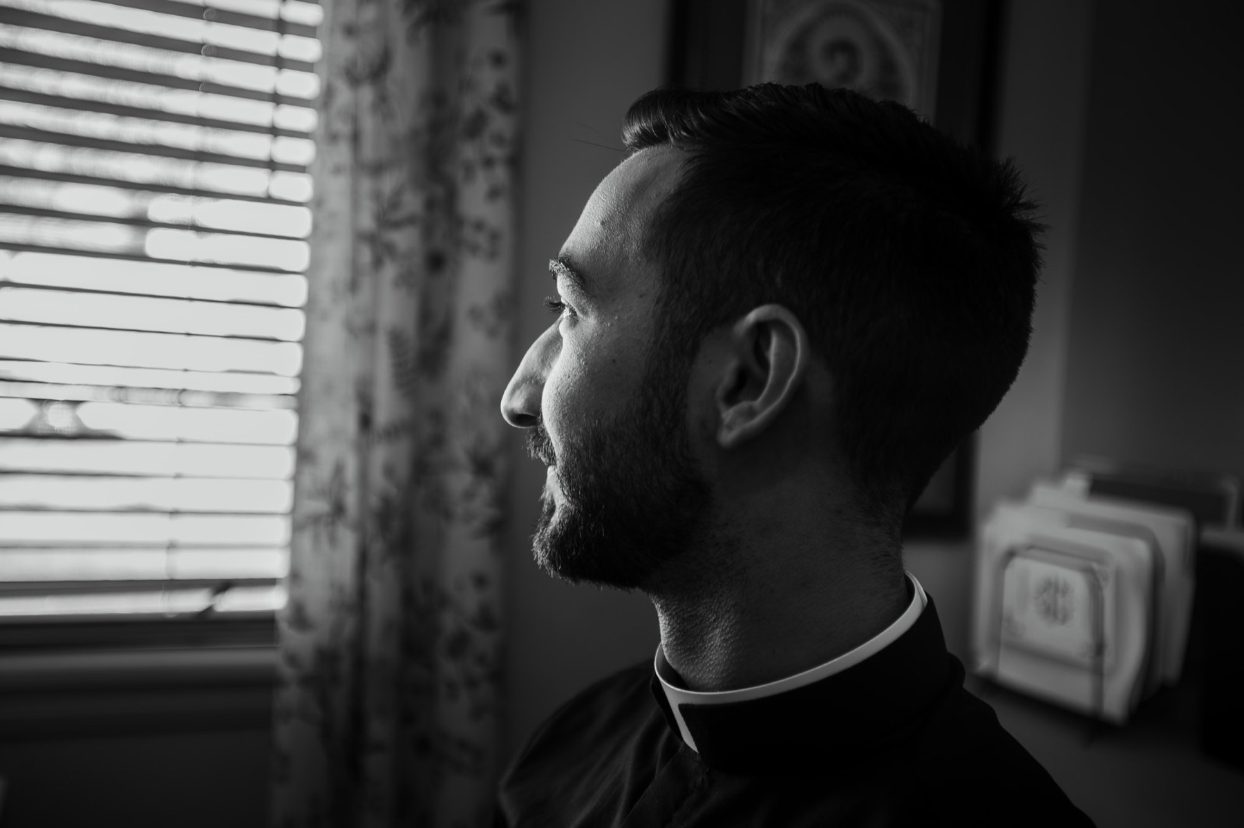 Father Larry in profile by a window