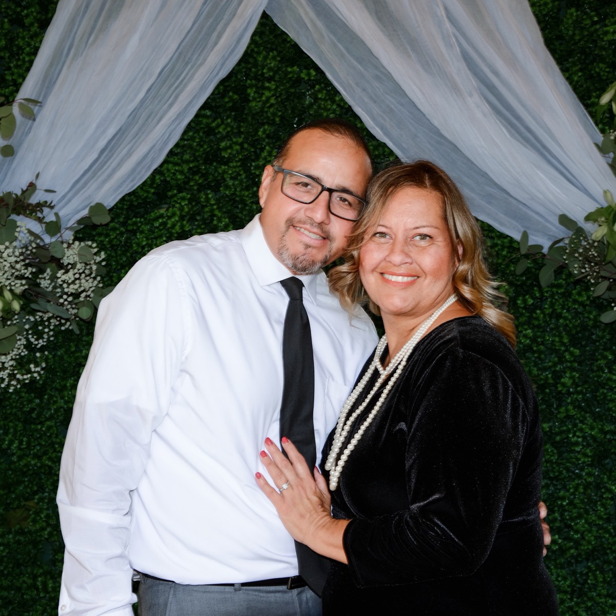 A married couple smiling together at a parish celebration
