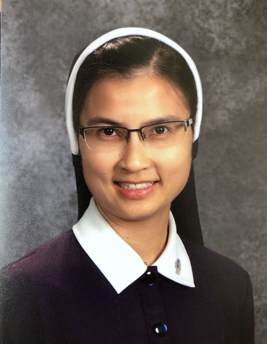 A young religious sister in her habit, smiling